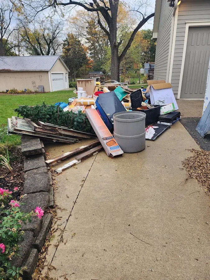Dumpster being loaded with debris for Demolition Dumpster Rental in Goldsby